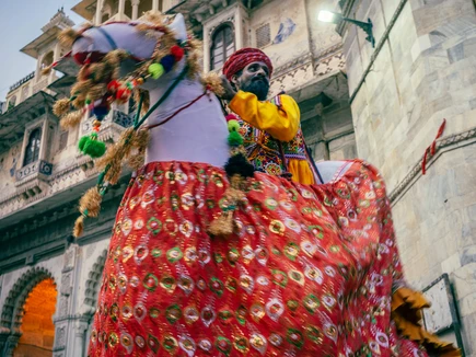 Indian man in traditional dress on a horse